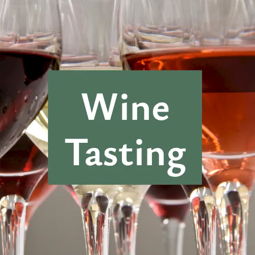 A wine tasting scene with many filled wine glasses, with the words &ldquo;Wine Tasting&rdquo; overlaid on the image.